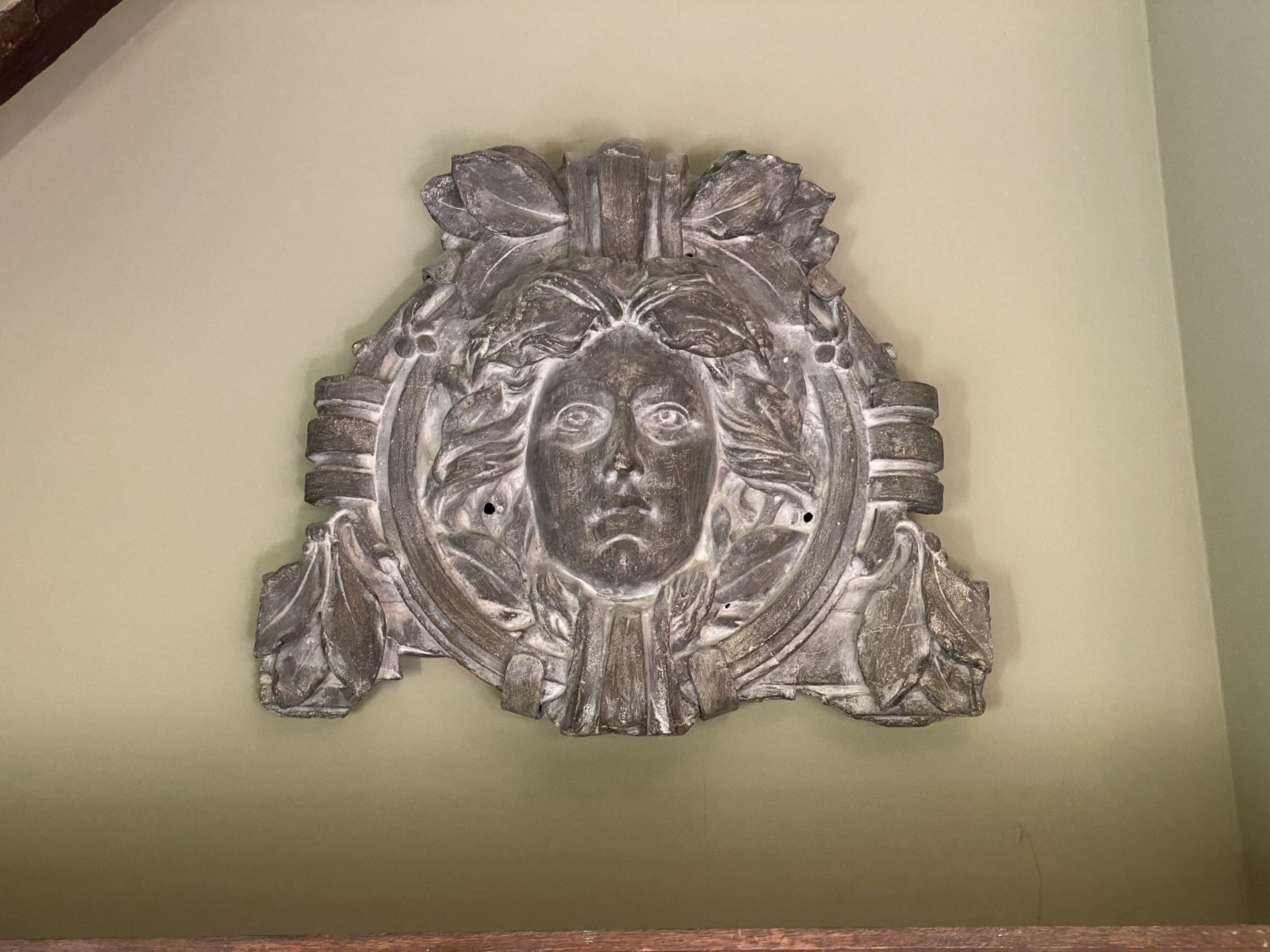 A pair of grey painted composition wall masks, width 80cm height 88cm